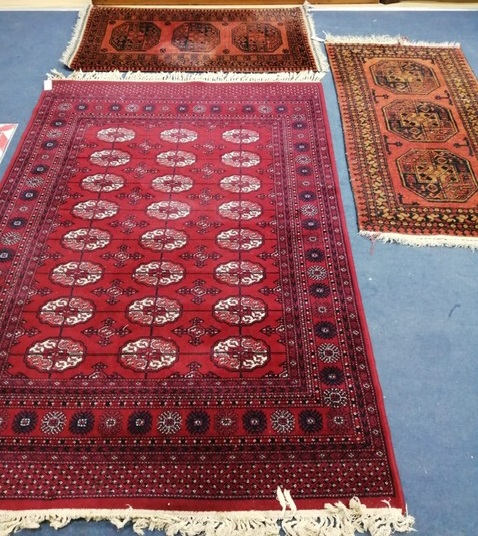 A Bokhara style rug and pair of Afghan rugs Largest 196 x 140cm